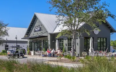 a group of people sitting outside of a building at Winters End by Oversee 30A in Santa Rosa Beach