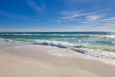 a beach with the ocean on a sunny day at EPIC Beach House with Private Pool, 175 ft to the BEACH, U Gotta See It! in Panama City Beach
