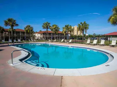 a swimming pool at a resort with palm trees at Horizon South #76E in Panama City Beach