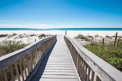 a boardwalk to the beach on a sunny day at Edgewater Villa #2008 Gulf Breeze Getaway in Panama City Beach