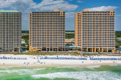 a beach in front of two tall buildings at Splash 507E in Panama City Beach