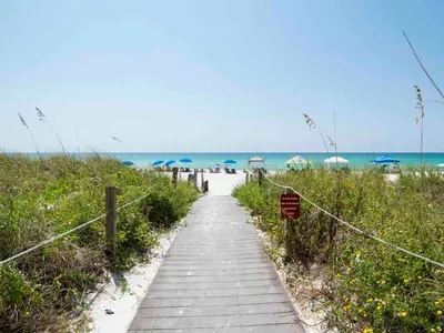 a walkway to the beach with umbrellas and the ocean at Dunes of Panama #B203 in Panama City Beach