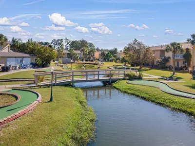 a bridge over a river in a park at Gulf Highlands #222 in Panama City Beach