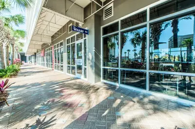 a building with palm trees in front of it at Laketown Wharf 1523 by Emerald Coast Retreats in Panama City Beach