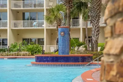 a pool with a fountain in front of a hotel at Shores Of Panama #1930 in Panama City Beach