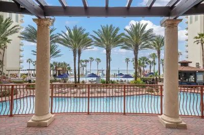 a view of the pool at the resort with palm trees at Shores Of Panama #1926 in Panama City Beach