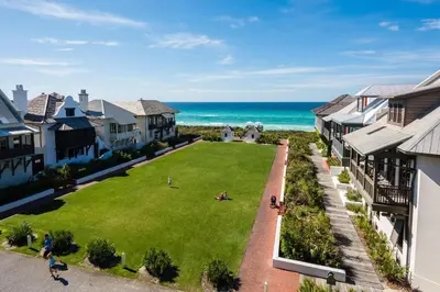 an aerial view of a yard with houses and the ocean at Highland Carriage House in Rosemary Beach