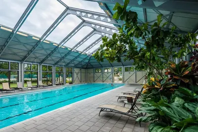 an indoor swimming pool with a glass ceiling at Lola's Carriage House in Rosemary Beach