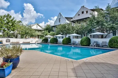 a swimming pool in front of a house at Butterfly Carriage House in Rosemary Beach