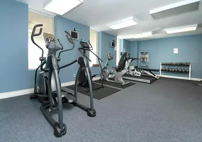 a gym with three tread machines in a room at Grandview East 1002 in Panama City Beach