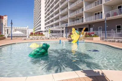 a pool with a green turtle in the water at Laketown Wharf #1219 by Nautical Properties in Panama City Beach