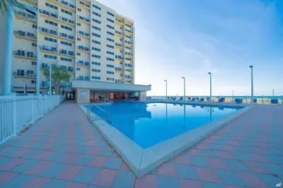a swimming pool in front of a large building at Beautiful Beach Front Condo at Pinnacle Port A-125 in Panama City Beach