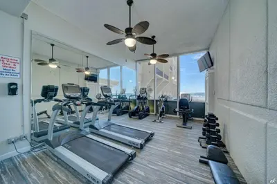 a gym with treadmills and elliptical machines at Beautiful Beach Front Paradise at Pinnacle Port B2-608! in Panama City Beach