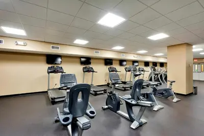 a gym with several rows of exercise bikes and treadmills at Emerald Beach Resort 234 | Roo’s Rendezvous in Panama City Beach