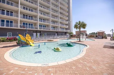 a pool in front of a large apartment building at Laketown Wharf #624 Beautiful Gulf View by Nautical Properties in Panama City Beach