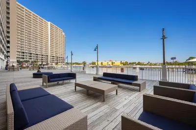 a patio with couches and tables on a building at Laketown Wharf #1818 in Panama City Beach