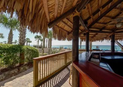 a resort deck with a hot tub on the beach at Calypso 908W Stunning condo, beach front, and immaculate in Panama City Beach