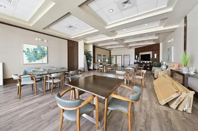 a waiting room with tables and chairs in a building at 1403 Aqua in Panama City Beach