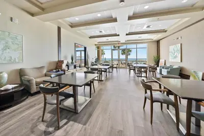 a waiting room at a hotel with tables and chairs at Aqua 2008 in Panama City Beach