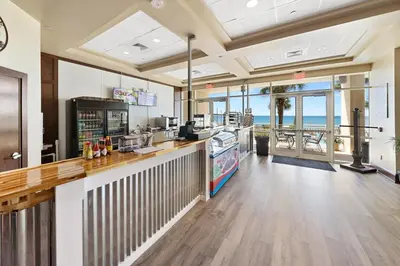 a restaurant with a counter with a view of the ocean at Aqua 2008 in Panama City Beach