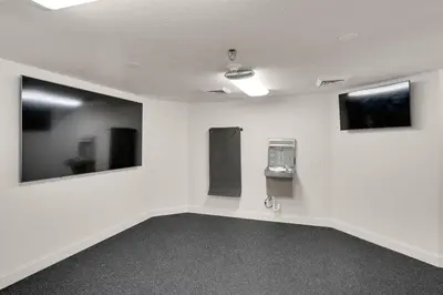 an empty room with white walls and mirrors at Calypso 209E 2nd floor Corner Unit 2 BR direct beach front in Panama City Beach