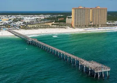 an aerial view of a pier over the ocean with a beach at 408E Calypso Elegant beach front Beach Svc Included in Panama City Beach