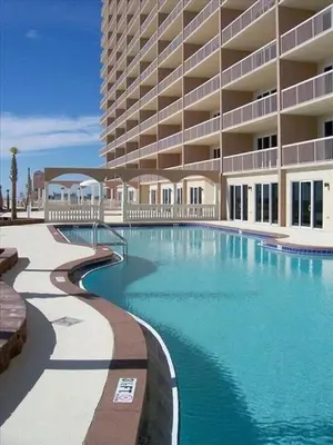 a swimming pool in front of a large building at Sunrise 2401 in Panama City Beach