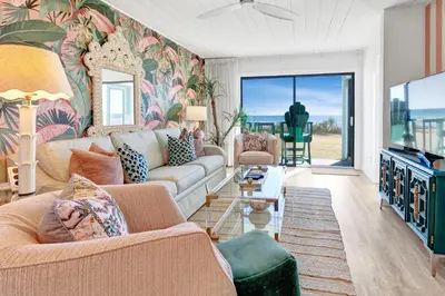 a living room with a couch and a tv at Gulf Front, Seagrove Beach, Sleeps 6, 1st floor, private beach access!! in Seagrove Beach