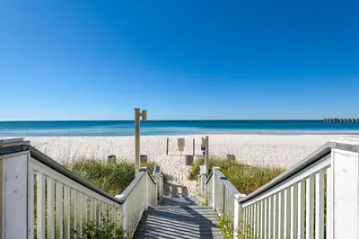 a stairway to the beach with the ocean in the background at Calypso 3-1107 in Panama City Beach