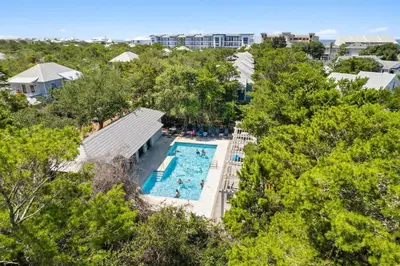 an overhead view of a pool at a resort at The Story House Walk To Beach Pet Friendly in Seacrest