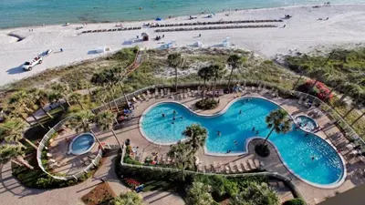 an overhead view of a swimming pool next to a beach at Grand Panama 1101 in Panama City Beach