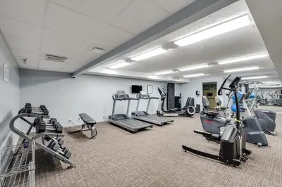 a gym with several treadmills and machines in a room at Watercrest 209 White-Sands Getaway - Sleeps 8 in Panama City Beach