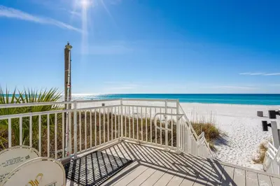 a gate to the beach with the ocean in the background at Watercrest 902 - Ocean Pearl Retreat - Renovated! in Panama City Beach