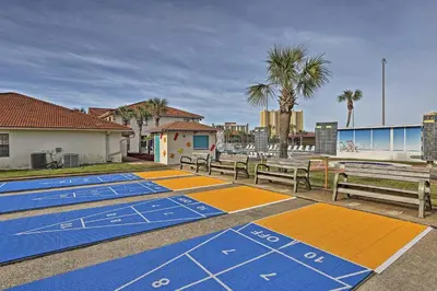 a row of benches sitting next to the beach at Walk to Beaches Resort Getaway Near Pier Park! in Panama City Beach
