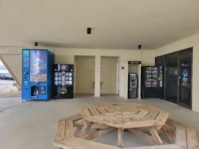 a room with a wooden table and two gas pumps at Sunbird Resort 11th Floor Free Beach Chairs - by Sunbird Rentals in Panama City Beach