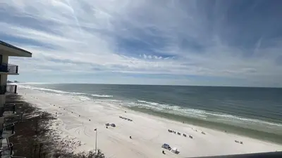 a view of a beach with people and the ocean at Sunbird Resort 8th Floor Sunsets - by Sunbird Rentals in Panama City Beach