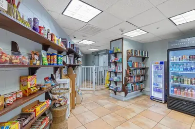 a store aisle with shelves of food and drinks at Grand Panama by Panhandle Getaways in Panama City Beach