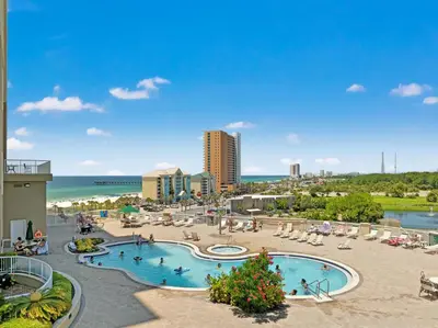 a resort with a swimming pool and a beach at Grand Panama by Panhandle Getaways in Panama City Beach