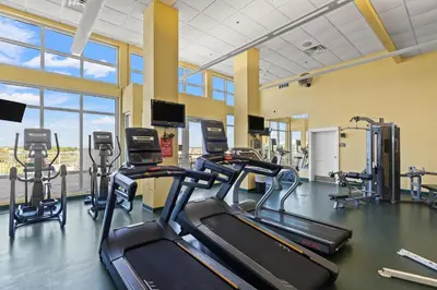 a gym with treadmills and elliptical machines at Grand Panama by Panhandle Getaways in Panama City Beach