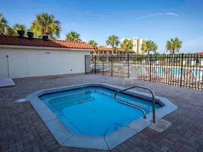 a swimming pool in the middle of a brick patio at Horizon South #76G in Panama City Beach