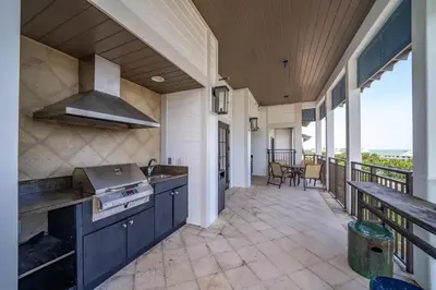a kitchen with a stove and a balcony at WaterHouse 204 in Inlet Beach