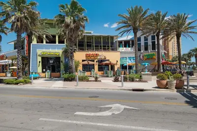 an empty street in front of a building with palm trees at Tidewater Escape: 1BR/2BA beachfront condo, sleeps 6, Gulf views & comfort! in Panama City Beach