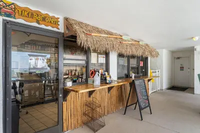 a restaurant with a bar with a sign in front of it at Watercrest Waves! Beachfront 2BR/2BA condo, Sleeps 8, Stunning Gulf Views! in Panama City Beach