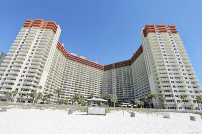 two large buildings on the beach with a beach at Shores of Panama 1602 condo in Panama City Beach
