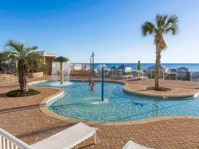 a pool with palm trees and a person playing in it at Laketown Wharf #913 in Panama City Beach