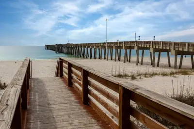 a wooden pathway to a pier on the beach at Aqua 0208 in Panama City Beach