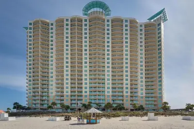 a large building on the beach with a beach at Aqua 0302 in Panama City Beach