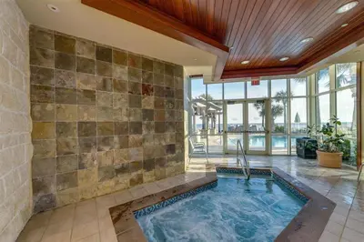 an indoor swimming pool in a house with a tile wall at Aqua 0611 in Panama City Beach