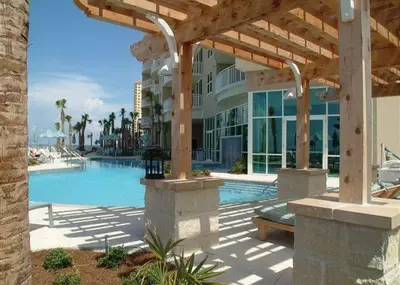 a large building with a swimming pool next to a resort at Aqua 1908 in Panama City Beach