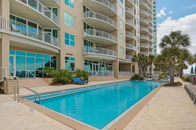 a swimming pool in front of a apartment building at Aqua 0904 in Panama City Beach
